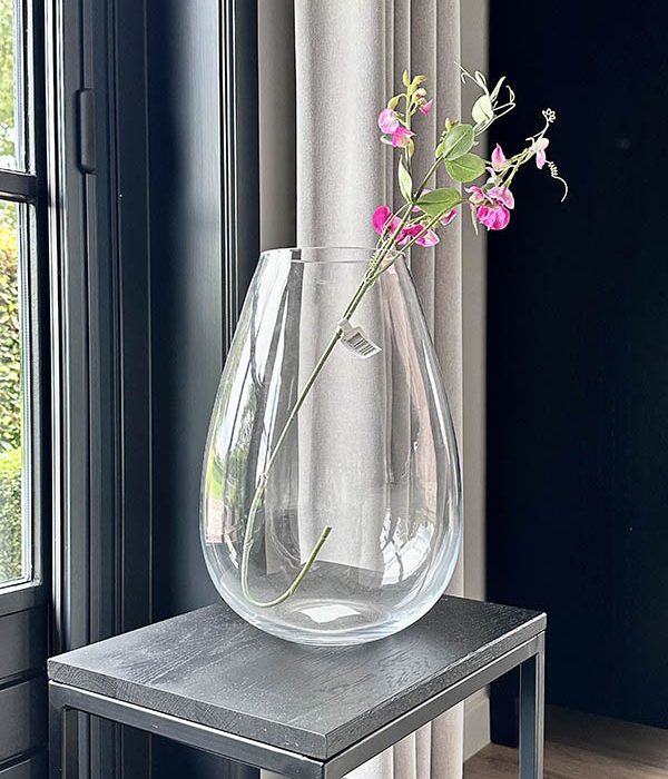 Bloemenvaas Stone van Alflora in transparant glas, gestyled met roze bloemen op een moderne houten tafel